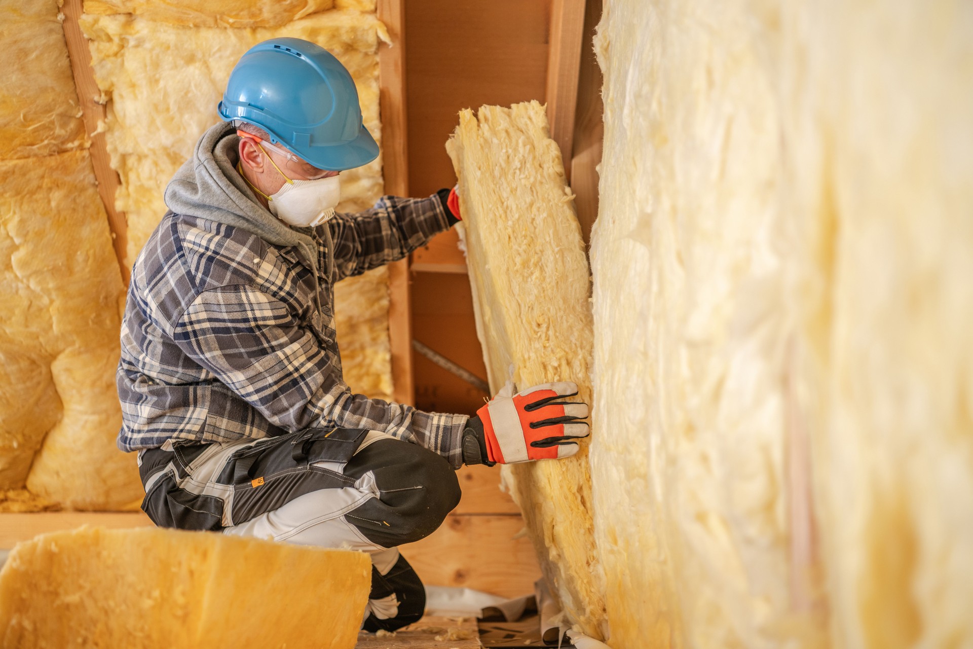 Construction Worker Insulating a Wall at a Building Site